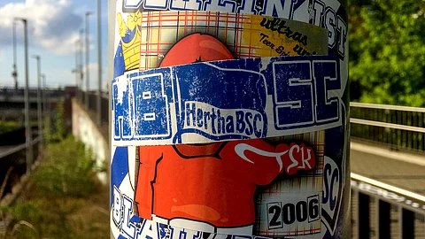 Stickers of the German first divsion, Bundesliga, soccer teams Hertha BSC Berlin and 1.FC Union Berlin are pictured in Berlin, Germany, Sunday, May 3, 2020. Rival Hertha Berlin and Union Berlin supporters have been engaged in an battle for supremacy that has left the city's lampposts, road signs, transit stops and more festooned with stickers in their respective club colors.