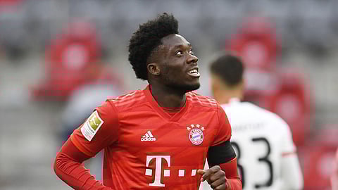 Bayern Munich's Alphonso Davies celebrates scoring Munich's fourth goal during the German Bundesliga soccer match between Bayern Munich and Eintracht Frankfurt in Munich, Germany, Saturday, May 23, 2020.