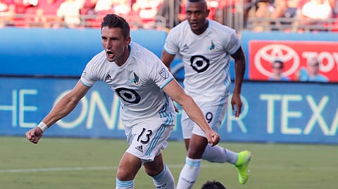 In this Aug. 10, 2019, file photo, Minnesota United's Ethan Finlay (13) and Angelo Rodriguez, rear left, celebrate Finlay's goal against FC Dallas in the first half of an MLS soccer match in Frisco, Texas. Major League Soccer and its players' union reached an agreement that paves the way for a summer tournament in Florida after the season was suspended by the coronavirus pandemic.