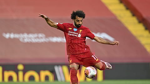 Liverpool's Mohamed Salah scores the second goal during the English Premier League soccer match between Liverpool and Crystal Palace at Anfield Stadium in Liverpool, England, Wednesday, June 24, 2020.