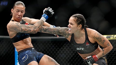 This Dec. 14, 2019, file photo shows Amanda Nunes, right, hitting Germaine de Randamie in a mixed martial arts women's bantamweight championship bout at UFC 245, in Las Vegas.