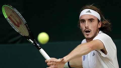 In this Friday, March 6, 2020 file photo, Stefanos Tsitsipas of Greece prepares to return the ball to Alberto Lim of the Philippines during their Davis Cup World Group II play-offs first round singles match in Manila, Philippines. With tennis majors on hold and discussions ongoing over whether the U.S. Open or the French Open can even take place later this year, a new digitally friendly tournament starts Saturday in southern France with four Top 10-ranked players involved.