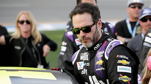 In this Feb. 16, 2020 file photo Jimmie Johnson climbs into his car before the NASCAR Daytona 500 auto race at Daytona International Speedway in Daytona Beach, Fla.