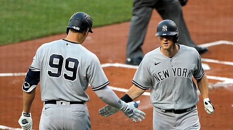 New York Yankees' Aaron Judge (99) greets DJ LeMahieu, right, after LaMahieu hit a solo home run off Baltimore Orioles starting pitcher Asher Wojciechowski during the first inning of a baseball game, Wednesday, July 29, 2020, in Baltimore.