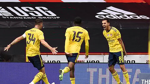 Arsenal's Dani Ceballos, right, celebrates with his teammates after scoring his side's second goal during the FA Cup sixth round soccer match between Sheffield United and Arsenal at Bramall Lane in Sheffield, England, Sunday, June 28, 2020.