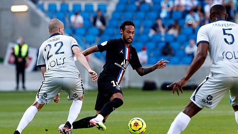 Paris Saint Germain's Neymar, center, challenges for the ball with Victor Lekhal of Le Havre AC, left, and Fernand Mayembo, right, during a friendly soccer match between Paris Saint Germain and Le Havre, in Le Havre, western France, Sunday, July 12, 2020.