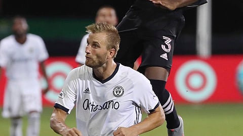 Inter Miami's Andres Reyes leaps over Philadelphia Union's Kacper Przybylko (23) during an MLS soccer match Tuesday, July 14, 2020, in Kissimmee, Fla.