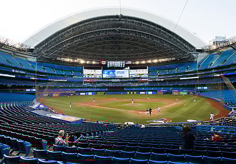 Photographers cover an intra-squad game in an empty stadium in Toronto, Friday, July 17, 2020. (Nathan Denette/The Canadian Press via AP)