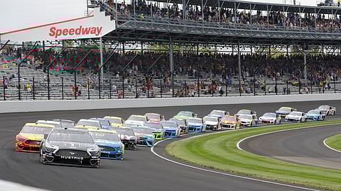 In this Sept. 8, 2019, file photo, Kevin Harvick leads the field through the first turn on the start of the NASCAR Brickyard 400 auto race at Indianapolis Motor Speedway in Indianapolis. The once frosty schism between the two biggest racing series in the United States has thawed and NASCAR's elite Cup Series will share a venue with IndyCar on the same weekend for the first time in history.