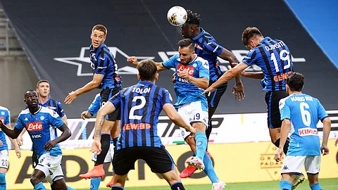 Atalanta's Duvan Zapata, top center, heads the ball ahead of Napoli's Nikola Maksimovic during a Serie A soccer match between Atalanta and Napoli, at Bergamo's Stadium, northern Italy, Thursday, July 2, 2020.