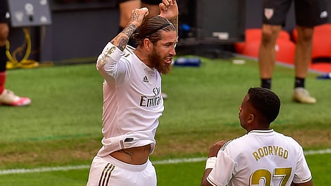 Real Madrid's Sergio Ramos, left, celebrates after scoring the opening goal from a penalty shoot during the Spanish La Liga soccer match between Athletic Club and Real Madrid at the San Manes stadium in Bilbao, Spain, Sunday, July 5, 2020.