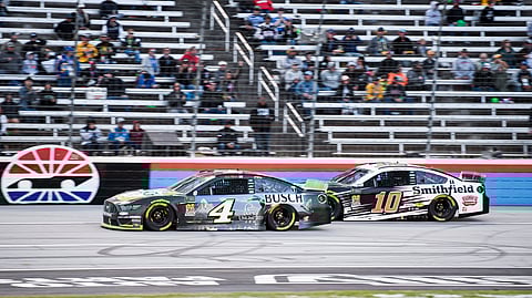 In this Nov. 3, 2019, file photo, Kevin Harvick (4) and Aric Almirola (10) battle for position during a NASCAR Cup Series auto race at Texas Motor Speedway, in Fort Worth, Texas.