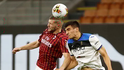 AC Milan's Ante Rebic, left, jumps for a header with Atalanta's Bosko Sutalo during the Serie A soccer match between AC Milan and Atalanta at the San Siro stadium, in Milan, Italy, Friday, July 24, 2020.