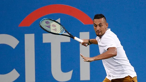 In this Saturday, Aug. 3, 2019, file photo, Nick Kyrgios, of Australia, returns the ball to Stefanos Tsitsipas, of Greece, during a semifinal at the Citi Open tennis tournament in Washington. The Citi Open in Washington, scheduled to start with Aug. 13 qualifying, was called off Tuesday, July 21, 2020, because of what tournament manager Mark Ein said are “too many unresolved external issues, including various international travel restrictions as well as troubling health and safety trends.”