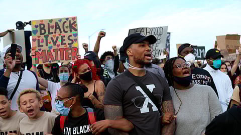 Portland Trailblazers' Damian Lillard, second from right, joins other demonstrators in Portland, Ore., during a protest against police brutality and racism sparked by the death of George Floyd, who died May 25 after being restrained by police in Minneapolis.