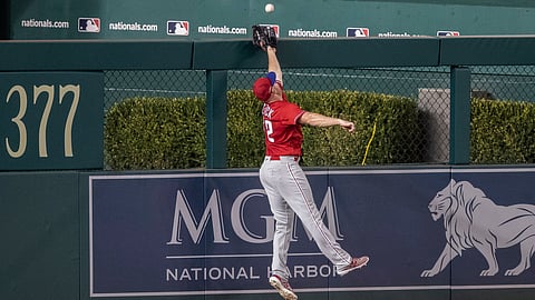 Phillies' left fielder Kyle Garlick can't reach a home run by the Nationals' Jake Noll on Saturday