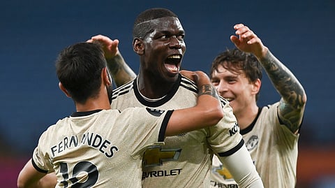 Manchester United's Paul Pogba, centre, celebrates with teammates after scoring his team's third goal during the English Premier League soccer match between Aston Villa and Manchester United at Villa Park in Birmingham, England, Thursday, July 9, 2020.
