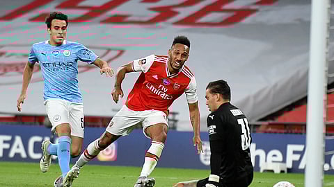 Arsenal's Pierre-Emerick Aubameyang, centre, scores his team's second goal during the FA Cup semifinal soccer match between Arsenal and Manchester City at Wembley in London, England, Saturday, July 18, 2020.