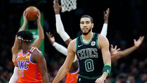 FILE - In this March 8, 2020, file photom, Boston Celtics' Jayson Tatum (0) walks on the court during the second half of an NBA basketball game against the Oklahoma City Thunder in Boston. Before the pandemic forced the NBA to pause its season, the Celtics were a team eager to figure out what they could be. It also remains to be seen whether fellow All-Star Jayson Tatum will be able to play at the high level he was before the season was suspended.(AP Photo/Michael Dwyer, File)
