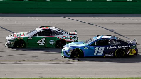 Kevin Harvick (4) and Martin Truex Jr. (19) run during a NASCAR Cup Series auto race Sunday, July 12, 2020, in Sparta, Ky.