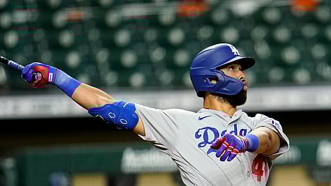 os Angeles Dodgers' Edwin Rios watches his two-run home run against the Houston Astros during the 13th inning of a baseball game Wednesday, July 29, 2020, in Houston. The Dodgers won 4-2 in 13 innings.