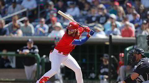 In this March 9, 2020, file photo, Philadelphia Phillies' Bryce Harper bats during a spring training baseball game in Clearwater, Fla.