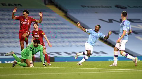 Manchester City's Raheem Sterling, second right, celebrates after his team's fourth goal during the English Premier League soccer match between Manchester City and Liverpool at Etihad Stadium in Manchester, England, Thursday, July 2, 2020. (AP Photo/