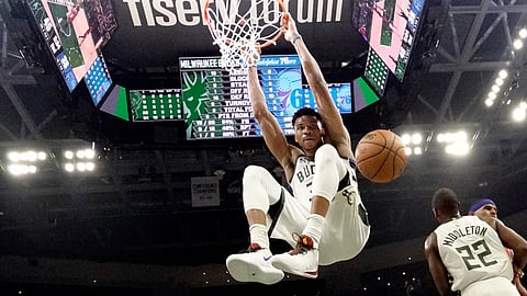 In this Feb. 22, 2020, file photo, Milwaukee Bucks' Giannis Antetokounmpo dunks during the first half of an NBA basketball game against the Philadelphia 76ers in Milwaukee. The Bucks believe they can build on the momentum they established while producing the NBA’s best record before the pandemic-imposed hiatus.