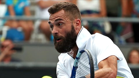 FILE - In this Wednesday, Jan. 22, 2020 file photo, France's Benoit Paire makes a backhand return to Croatia's Marin Cilic during their second round singles match at the Australian Open tennis championship in Melbourne, Australia. Paire has tested positive for the coronavirus and was removed from the U.S. Open field, a person familiar with the situation told The Associated Press on Sunday, Aug. 30, 2020.