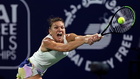 In this Feb. 22, 2020, file photo, Romania's Simona Halep returns the ball to Kazakhstan's Elena Rybakina during the final match of the Dubai Duty Free Tennis Championship in Dubai, United Arab Emirates. Halep says she will skip the U.S. Open. She says she wants to put her health first and prefers to stay in Europe amid the coronavirus pandemic.