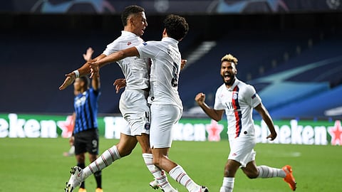 PSG's Marquinhos, centre, celebrates with teammate Thilo Kehrer, left, after scoring his team's first goal during the Champions League quarterfinal match between Atalanta and PSG at Luz stadium, Lisbon, Portugal, Wednesday, Aug. 12, 2020.