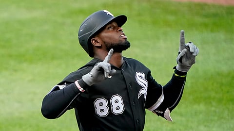 Chicago White Sox's Luis Robert celebrates as he crosses the plate after hitting a solo home run during the second inning of the team's baseball game against the Kansas City Royals on Saturday, Aug. 1, 2020, in Kansas City, Mo.