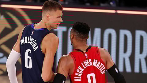The Mavericks' Kristaps Porzingis (left) and the Rockets' Russell Westbrook congratulate each on combining to get their teams to break the 300-point barrier Friday