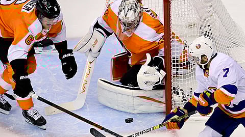 Philadelphia Flyers goaltender Carter Hart (79) makes a save as teammate Travis Sanheim (6) and New York Islanders right wing Jordan Eberle (7) vie for the rebound during first-period NHL Stanley Cup Eastern Conference playoff hockey game action in Toronto, Monday, Aug. 24, 2020.