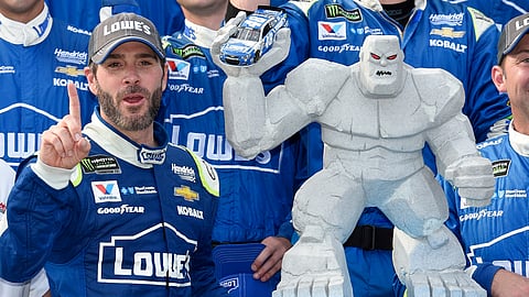 FILE - In this June 4, 2017, file photo, Jimmie Johnson, left, poses with the trophy in Victory Lane after he won a NASCAR Cup series auto race at Dover International Speedway in Dover, Del. Jimmie Johnson has a track-record 11 wins at Dover International Speedway. He’ll have to win No. 12 to guarantee a playoff spot and he has two shots this weekend when the NASCAR Cup series races on Saturday and Sunday.