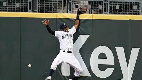 Seattle Mariners right fielder Mallex Smith hits the wall as he misses a deep fly ball from Colorado Rockies' Charlie Blackmon for a three-run double during the fifth inning of a baseball game Saturday, Aug. 8, 2020, in Seattle.