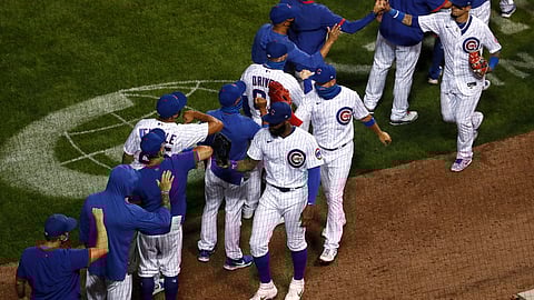 The Chicago Cubs celebrate after beating the Milwaukee Brewers during a baseball game in Chicago, on Thursday, Aug. 13, 2020. The Cubs won the game 4-2.