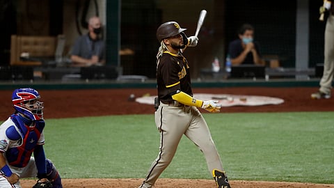 Texas Rangers catcher Jose Trevino and San Diego Padres' Fernando Tatis Jr. watch the flight of Tatis's grand slam ball that came off a pitch from Rangers relief pitcher Juan Nicasio in the eighth inning of a baseball game in Arlington, Texas, Monday Aug. 17, 2020. The shot also scored Jurickson Profar, Josh Naylor and Trent Grisham.