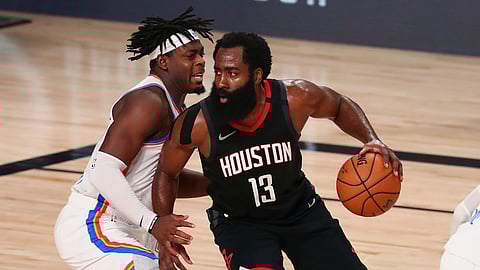 Houston Rockets guard James Harden (13) drives against Oklahoma City Thunder guard Luguentz Dort (left) during the second half of Game 4 of an NBA basketball first-round playoff series, Monday, Aug. 24, 2020, in Lake Buena Vista, Fla.