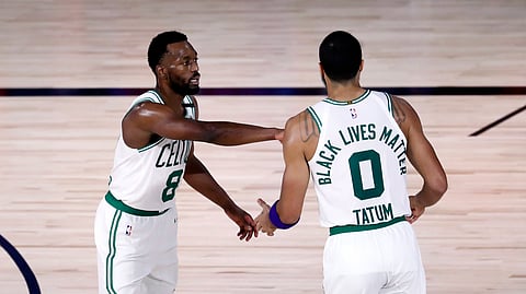 Boston Celtics guard Kemba Walker (8) and forward Jayson Tatum (0) react during the third quarter against the Philadelphia 76ers in Game 4 of an NBA basketball first-round playoff series, Sunday, Aug. 23, 2020, in Lake Buena Vista, Fla.