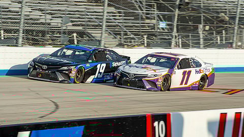 Martin Truex Jr. (19) and Denny Hamlin (11) drive during the NASCAR Cup Series auto race at Dover International Speedway, Saturday, Aug. 22, 2020, in Dover, Del.