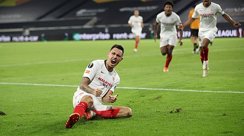 Sevilla's Lucas Ocampos celebrates after scoring his side's opening goal during the Europa League quarterfinal soccer match between Wolves and Sevilla at the MSV Arena in Duisburg, Germany, Tuesday, Aug. 11, 2020.