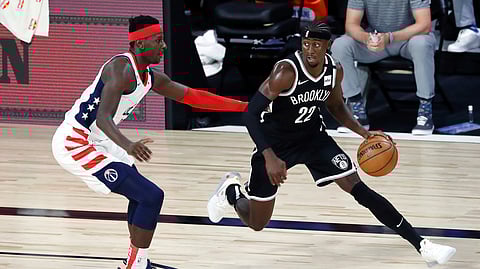 Brooklyn Nets guard Caris LeVert (22) dribbles against Washington Wizards forward Isaac Bonga (17) in the first half of an NBA basketball game Sunday, Aug. 2, 2020, in Lake Buena Vista, Fla.