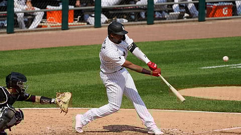 Chicago White Sox's Eloy Jimenez hits a three-run home run against the Pittsburgh Pirates during the fifth inning of a baseball game in Chicago, Wednesday, Aug. 26, 2020.