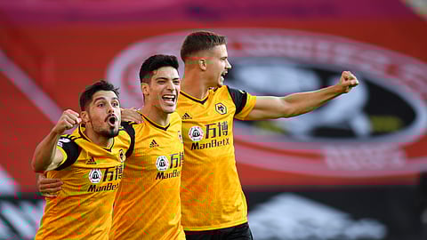 Wolverhampton Wanderers' Raul Jimenez, centre, celebrates scoring his sides first goal during the English Premier League soccer match between Sheffield United and Wolves at Bramall Lane stadium in Sheffield, England, Monday, Sept. 14, 2020.