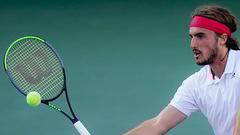 Stefanos Tsitsipas, of Greece, returns to Kevin Anderson, of South Africa, at the Western & Southern Open tennis tournament, Sunday, Aug. 23, 2020, in New York.