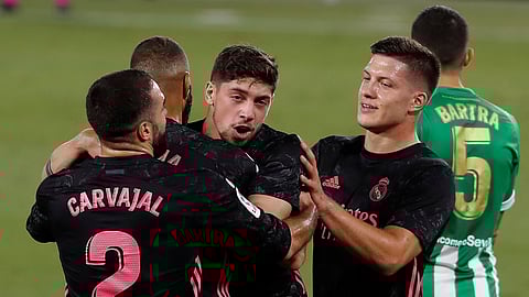 Real Madrid's Federico Valverde, center, celebrates after scoring the opening goal during the Spanish La Liga soccer match between Betis and Real Madrid at the at the Benito Villamarin stadium in Seville, Spain, Saturday, Sept. 26, 2020.