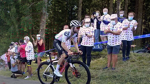 Spectators cheer Switzerland's Marc Hirschi as he climbs Suc au May pass during the stage 12 of the Tour de France cycling race over 218 kilometers from Chauvigny to Sarran, Thursday, Sept. 10, 2020.