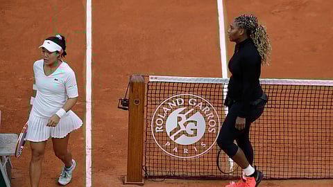 Serena Williams of the U.S. walks to her bench after defeating Kristie Ahn of the U.S., left, in the first round match of the French Open tennis tournament at the Roland Garros stadium in Paris, France, Monday, Sept. 28, 2020.