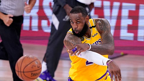 Los Angeles Lakers forward LeBron Jame makes a pass during the second half an NBA conference final playoff basketball game against the Denver Nuggets on Friday, Sept. 18, 2020, in Lake Buena Vista, Fla.